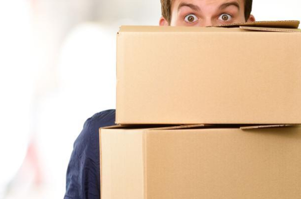 Man holding cardboard boxes, outdoor