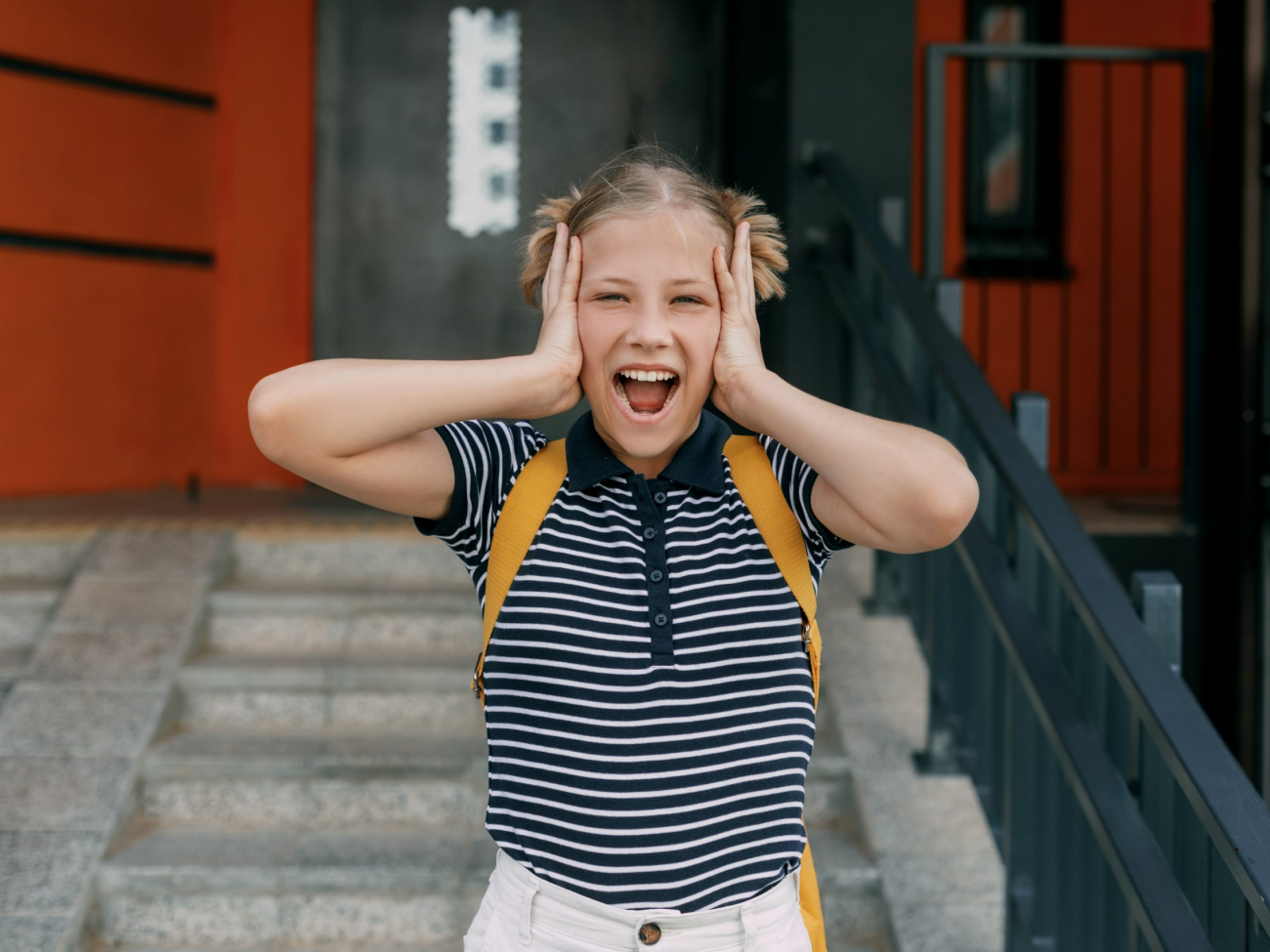 A charming schoolgirl holds her head, can't cope with stress and emotions.