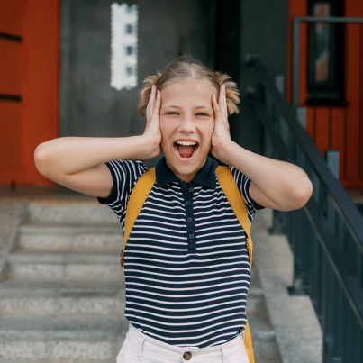 A charming schoolgirl holds her head, can't cope with stress and emotions.
