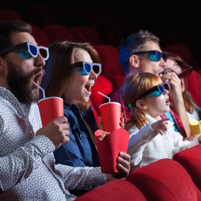 A variety of human emotions of friends holding a cola and popcorn in the cinema.