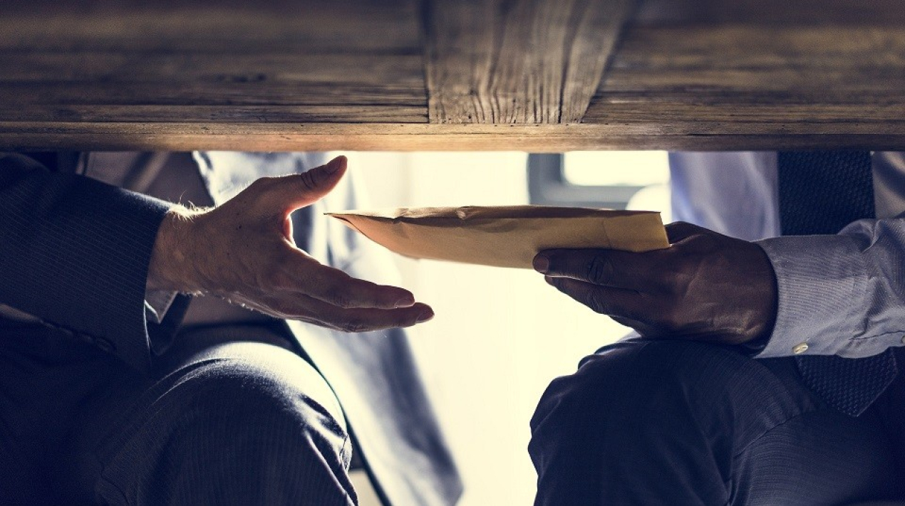 Business people sending documents under the table