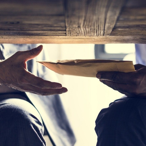 Business people sending documents under the table