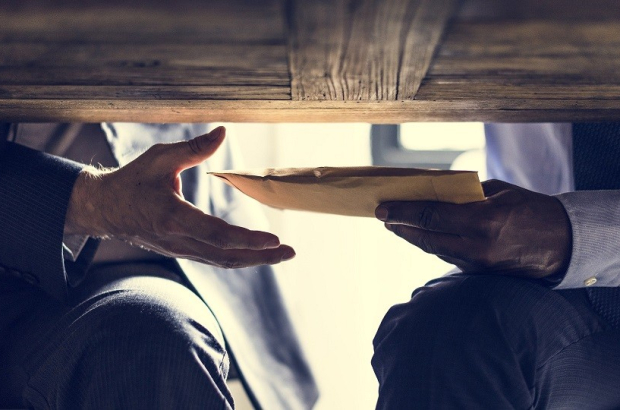 Business people sending documents under the table