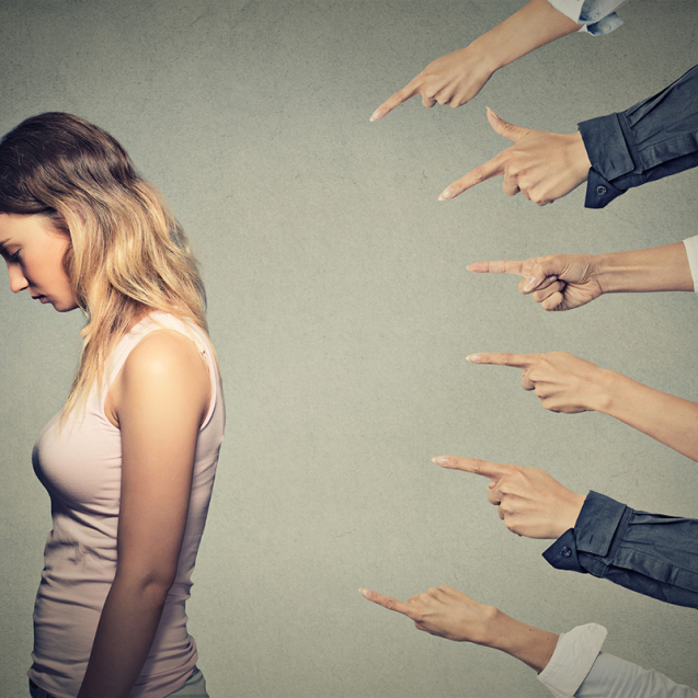 Concept of accusation guilty person girl. Side profile sad upset woman looking down many fingers pointing at her back isolated on grey office wall background. Human face expression emotion feeling