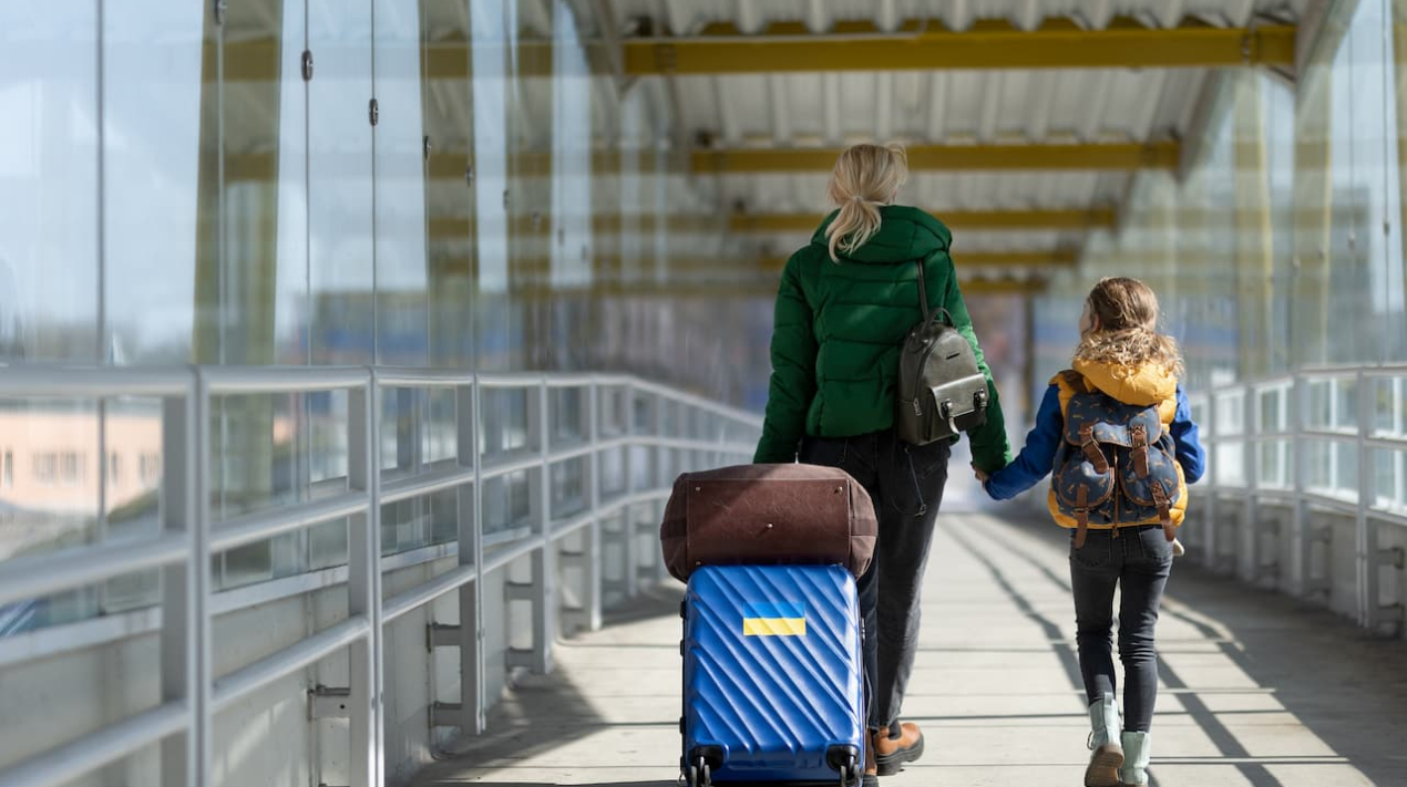 rear-view-of-ukrainian-immigrant-mother-with-child-2022-11-12-03-06-32-utc