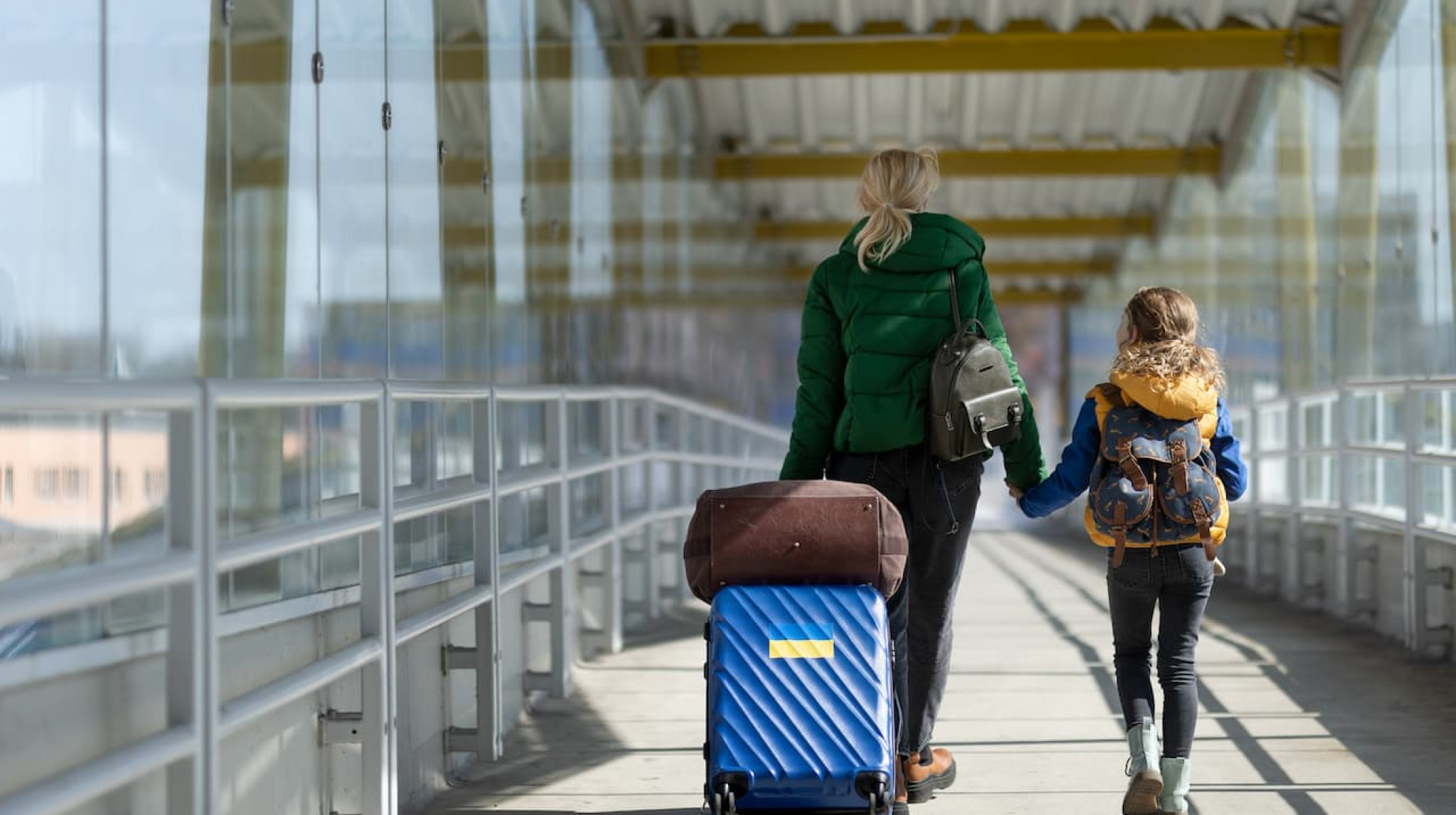 rear-view-of-ukrainian-immigrant-mother-with-child-2022-11-12-03-06-32-utc