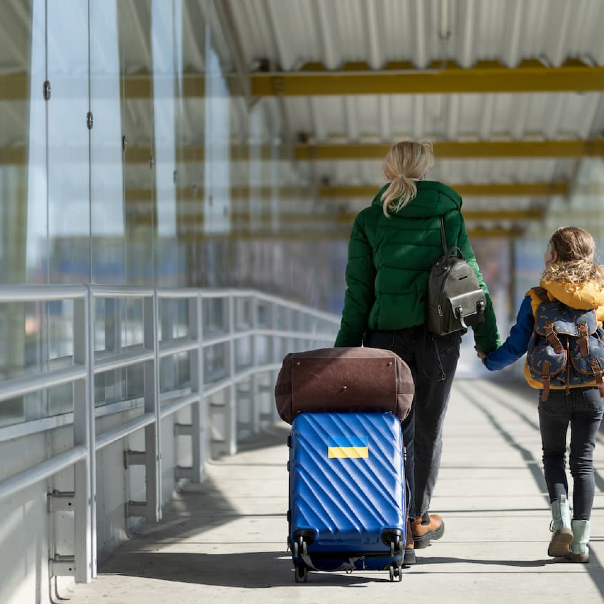 rear-view-of-ukrainian-immigrant-mother-with-child-2022-11-12-03-06-32-utc